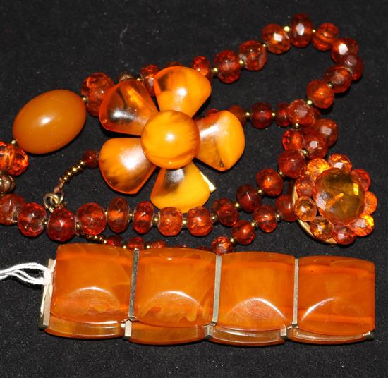 An amber bracelet, two amber brooches and an amber necklace.